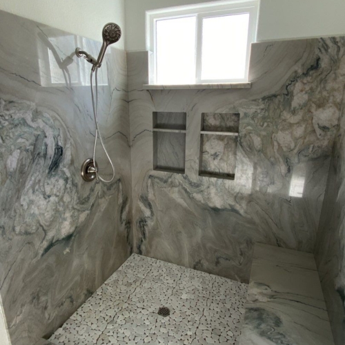 updated shower with marble slab