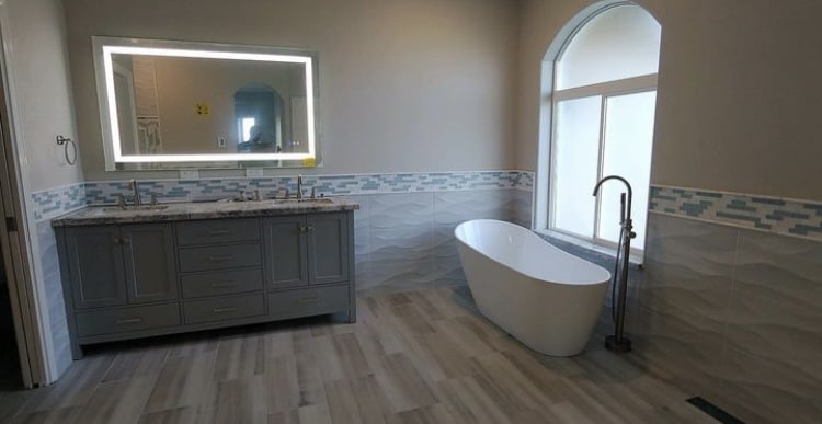 updated bathroom with vanity and tub