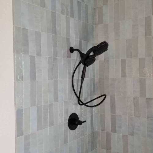 updated shower wall with black fixture
