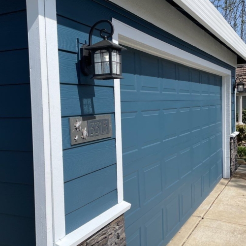 blue siding with brick on the bottom half